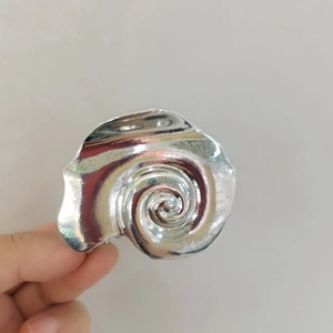 Silver metal hair claw clip in vintage conch shell design for beach vacations
