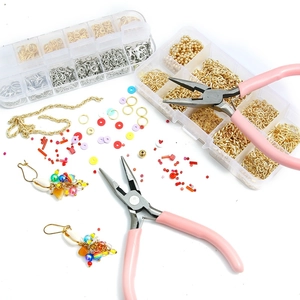 Pink jewelry tool set with needle nose pliers, assorted beads and metal jump rings