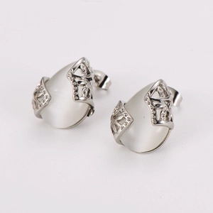 Elegant stainless steel teardrop jewelry set with white oval stones and intricate carving