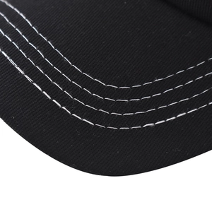 Detailed close-up of a black baseball cap brim with four rows of parallel white stitching