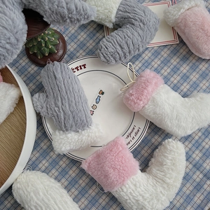 Détail de gants et chaussettes de Noël en peluche avec boucles de suspension décoratives