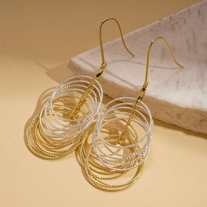 Multi-layer geometric circular metal earrings in gold and silver with twisted rope texture