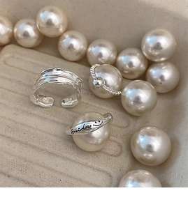 Close-up of S925 silver smile face rings with pearls and irregular minimalist design