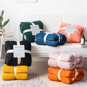 Close-up of thick flannel striped blankets with ribbon packaging and gift tags