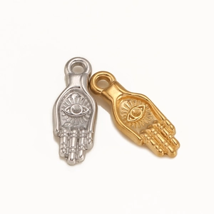 Vintage 18k gold and silver Hamsa hand pendants with evil eye relief detail