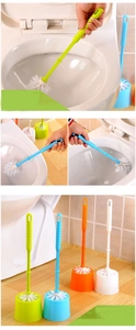 Detail view of colorful toilet brush set with holder in green blue orange and white