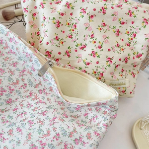 Detail of floral makeup bag with metal zipper and high-quality canvas fabric texture