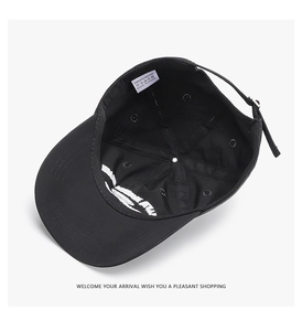 Detail view of the black polyester baseball cap interior with adjustable metal buckle