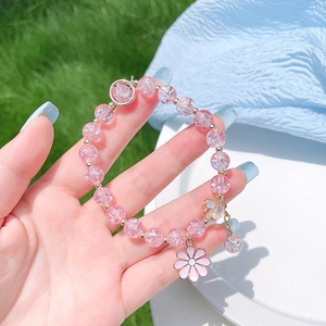 Pink beaded bracelet with daisy flower charm and golden accents for girls and women