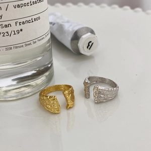 Close-up of gold and silver S925 sterling silver rings with unique bark texture