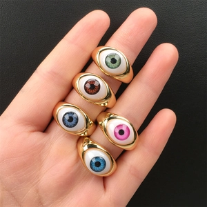 Detailed view of colorful evil eye resin rings in vibrant green, pink, and blue shades