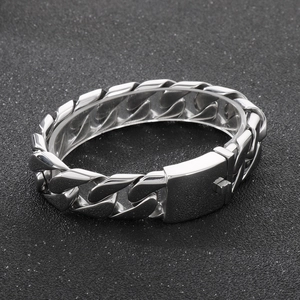 Macro detail of silver titanium steel Cuban link bracelet with secure box clasp closure
