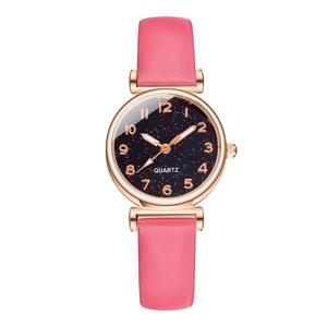 Detail of pink quartz watch with starry blue dial and rose gold numerals