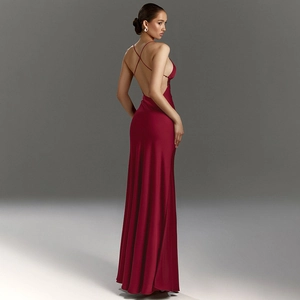 Detail of burgundy satin dress showing backless cross straps and sleek fabric drape