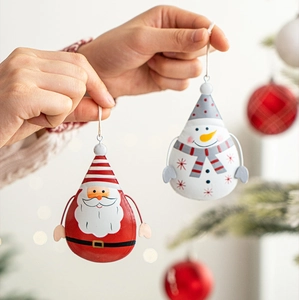 Detailed view of hand-held Nordic metal Santa and Snowman droplet Christmas ornaments