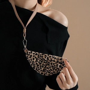 Detail of leopard print croissant coin purse necklace with pleated faux leather finish