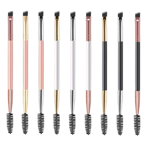Dual-ended eyebrow brushes with angled tips and spoolies in various colors on white background