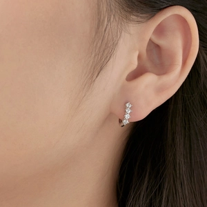 Close-up of S925 sterling silver hoop earrings with four sparkling zircon stones on ear