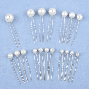 Detail view of 18-piece pearl U-shaped hair pins in 5 sizes on light blue background