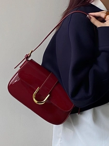 Vintage burgundy patent leather baguette bag with a signature gold horseshoe buckle