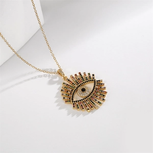 Detailed close-up of gold necklace with colorful zircon devil's eye palm pendant