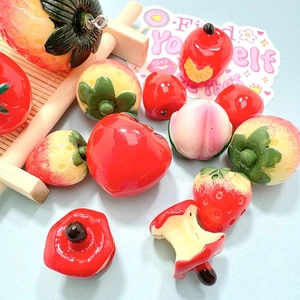Assorted colorful resin fruit charms including strawberry and apple for DIY crafts