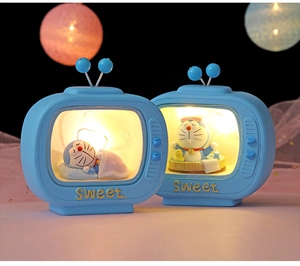 Close-up of blue TV-shaped night lights with Doraemon figurines and Sweet text