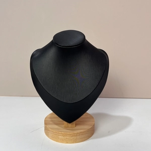 Detail of black matte necklace display stand with natural beech wood base for jewelry
