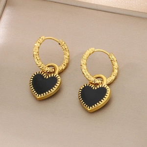 Détail de boucles d'oreilles créoles plaquées or 18 carats avec pendentif cœur noir
