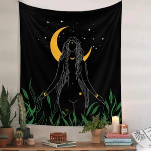 Detail of bohemian goddess tapestry with moon and stars on a white textured wall