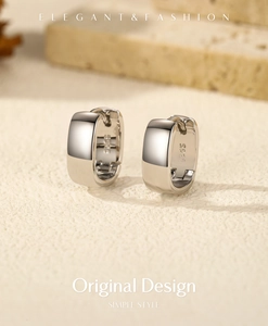 Macro detail of minimalist S925 sterling silver rectangular earrings with polished surface