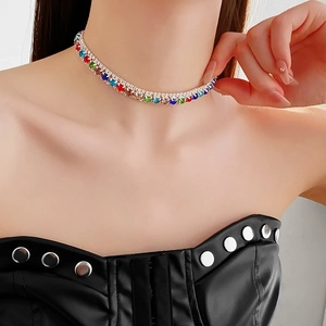Detail of multi-color rhinestone square necklace worn by a model on a silver base