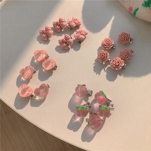 Cute pink hair clips set featuring bows, roses, hearts and peaches on white backdrop