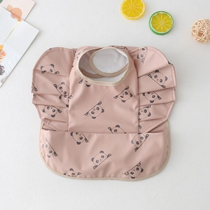 Detail of pink waterproof baby bib with panda pattern, frill sleeves and crumb catcher