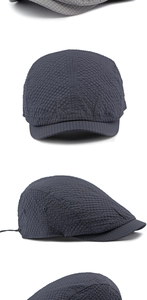 Detail of dark grey seersucker newsboy cap with metal eyelets and adjustable cord
