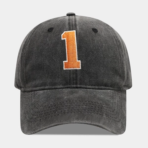 Detail of vintage washed charcoal baseball cap with orange number 1 embroidery