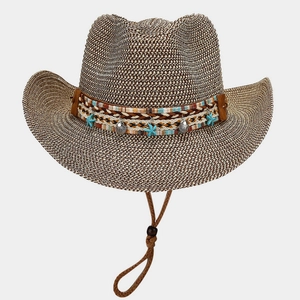 Detail of woven straw cowboy hat with starfish charms and ethnic pattern band