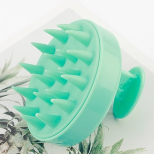 Detailed side view of a mint green silicone scalp massager brush with massage bristles