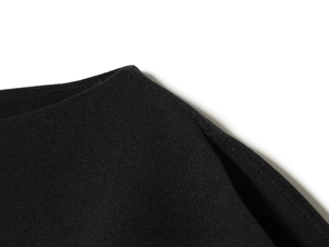 Close-up of the black bubble sleeve fabric showing textured knit material and stitching