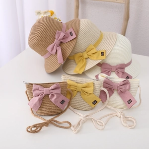 Detail of straw hat and matching bag set with cute bowknot and Hand made label