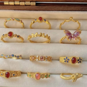 Vintage gold butterfly ring set with oval gemstones and enamel in a velvet box