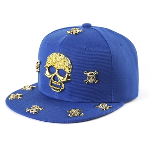 Dark blue hip hop flat brim hat featuring decorative gold metal skull studs and emblems