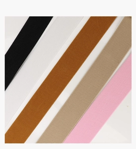 Detail of elastic waist belts in black, white, brown, beige, and pink colors