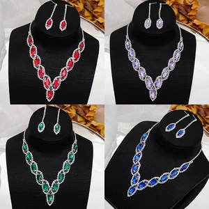 Macro detail of elegant bridal necklace sets in red, purple, green and blue crystal colors