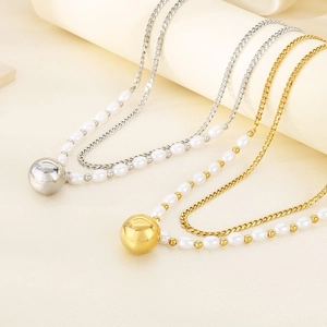 Detail of double-layer gold and silver necklaces with metal ball pendant and pearls
