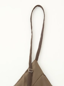 Detailed close-up of brown adjustable strap with metal slide on a bohemian style dress
