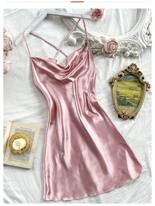 Detail of light pink satin nightdress with cowl neck and silky cross back straps