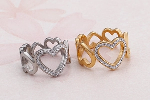 Macro shot of silver and gold heart rings with pavé set crystals and hollow band