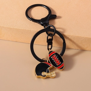 Detail of rugby helmet and ball pendant keychain with black metallic keyring for bag