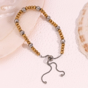 Detail view of two-tone 18K gold plated bead bracelet with adjustable draw-string closure